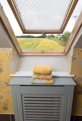 a skylight in a bathroom with a window at The Retreat- amazing scenic views of the Essex countryside! in Salcott