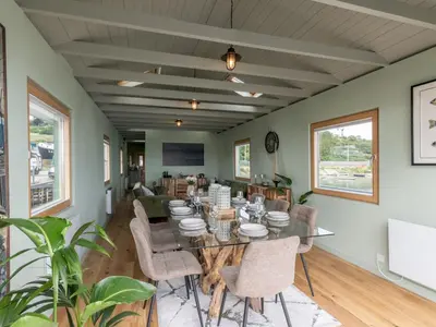a dining room with a table and chairs at The Pontoon - Pass the Keys in Southend-on-Sea