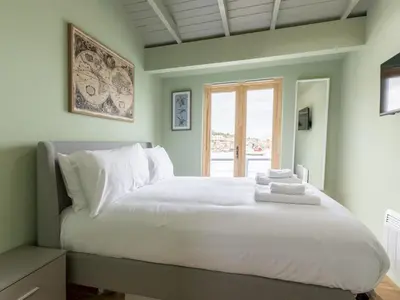 a bedroom with a large white bed with a window at The Pontoon - Pass the Keys in Southend-on-Sea