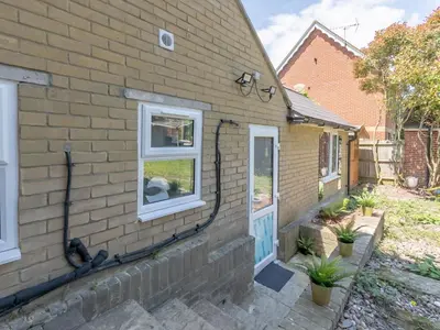 a brick house with a blue door and windows at Comfortable 2 Bed Apartment Pass the Keys in Basildon