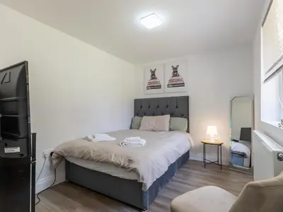 a bedroom with a bed with two shoes on the wall at Comfortable 2 Bed Apartment Pass the Keys in Basildon