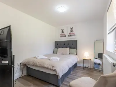 a bedroom with a bed and a tv in it at Comfortable 2 Bed Apartment Pass the Keys in Basildon