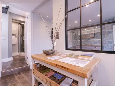 a room with a table with books and a window at Number 1 in Sudbury