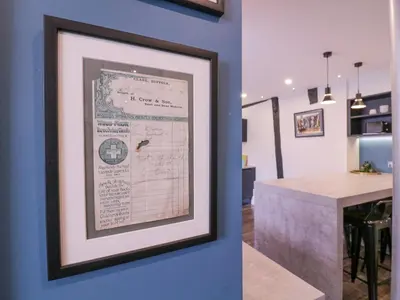 a framed picture hanging on a blue wall in a kitchen at Number 1 in Sudbury