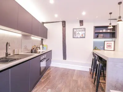 a kitchen with blue cabinets and a wooden floor at Number 1 in Sudbury