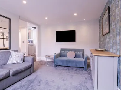 a living room with a couch and a tv at Number 1 in Sudbury