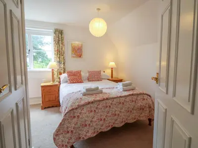 a bedroom with a bed with two pillows on it at 1 Market Hill in Woodbridge
