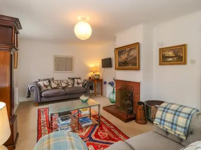 a living room with a couch and a fireplace at 1 Market Hill in Woodbridge