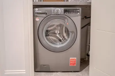 a washer and dryer sitting in a closet at Royal Oak Apartments 9 - Free Secure Parking - 2 Bedrooms - Perfect for Contractors in Brentwood