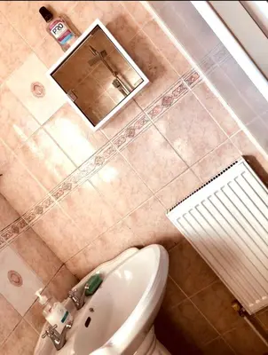 a bathroom with a toilet and a sink and a mirror at Ac Lounge 36 Room A in Rochford