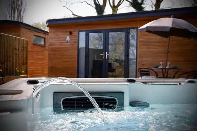 a hot tub with water coming out of it at Rocklands Retreat in Rockland Saint Peter