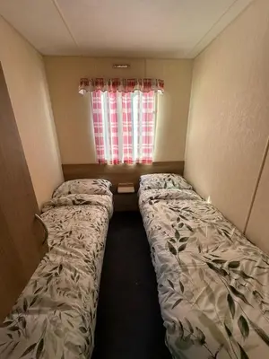 a small room with a bed and a window at Seawick Holiday Home Horizon 363 in Saint Osyth