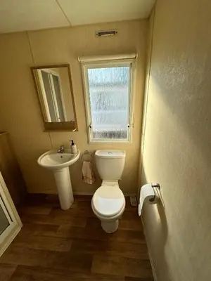a small bathroom with a toilet and a sink at Seawick Holiday Home Horizon 363 in Saint Osyth