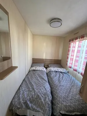 a small bedroom with two beds in it at Seawick Holiday Home Horizon 363 in Saint Osyth