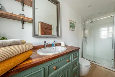 a bathroom with a sink and a shower at Cutbush Farm House in Hingham