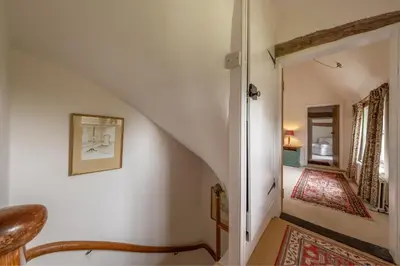 a hallway with a stairway leading into a house at Cutbush Farm House in Hingham