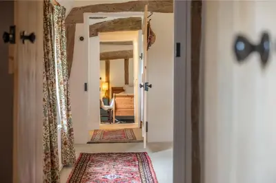 a hallway with a door leading to a bedroom at Cutbush Farm House in Hingham