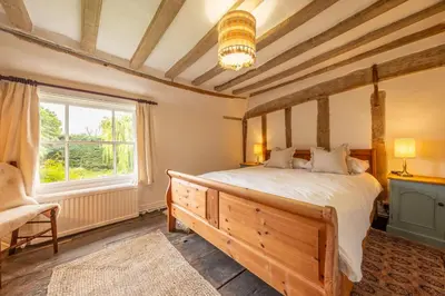a bedroom with a bed and a window at Cutbush Farm House in Hingham