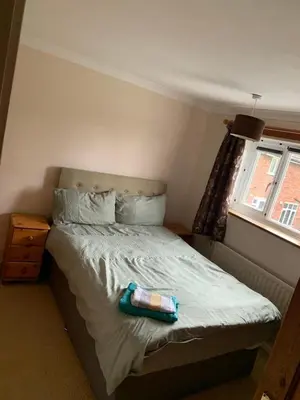 a small bed in a bedroom with a window at Lawrence House in Cambridge
