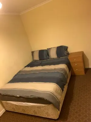 a bedroom with a bed with a night stand at Lawrence House in Cambridge