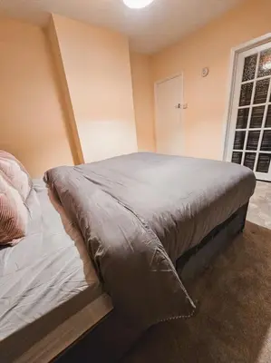 a bed in a room with a window at Spacious House in Ipswich in Ipswich