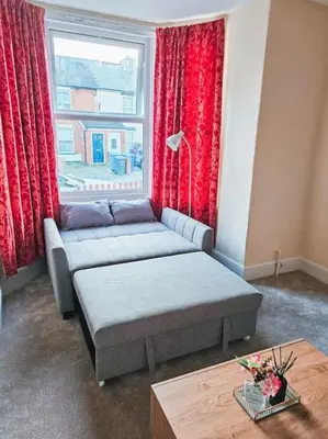 a living room with a couch and a window at Spacious House in Ipswich in Ipswich