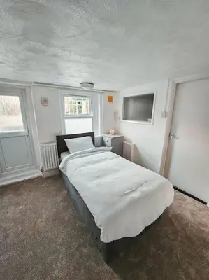 a bedroom with a large white bed in it at Spacious House in Ipswich in Ipswich