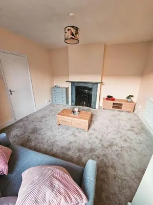 a living room with a couch and a fireplace at Spacious House in Ipswich in Ipswich