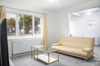 a living room with a couch and a glass table at Southend Retreat KING SUITE Luxury stay with parking in Southend-on-Sea
