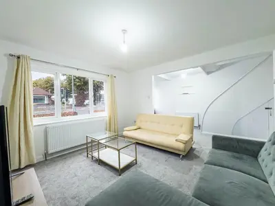 a living room with a couch and a table at Southend Retreat KING SUITE Luxury stay with parking in Southend-on-Sea