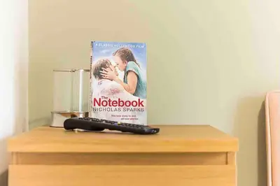 a book sitting on top of a table with a pen at By Buildersbeds - Colne House 4 bedrooms in Harold Wood