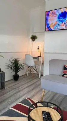 a living room with a couch and a table at By Buildersbeds - Heaton House 2 Bedrooms in Havering atte Bower