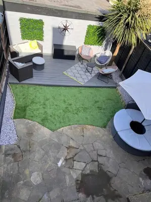 an aerial view of a patio with chairs and an umbrella at By Buildersbeds - Heaton House 2 Bedrooms in Havering atte Bower