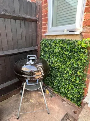 a bbq grill sitting outside of a house at By Buildersbeds - Heaton House 2 Bedrooms in Havering atte Bower