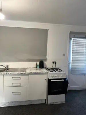 a kitchen with a stove and a sink at Cosy 1 Bedroom Bungalow Between Basildon & Wickford in Nevendon