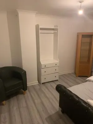 a bedroom with a bed and a chair and a dresser at At Apex house in Horndon on the Hill