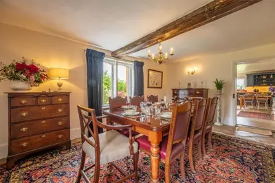 a dining room with a wooden table and chairs at Cutbush Farm House 6 in Hingham