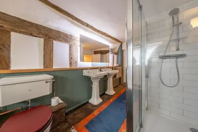 a bathroom with two sinks and a shower at Cutbush Farm House 6 in Hingham
