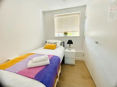 a small bedroom with a bed and a window at Apartment at Addenbrooke hospital and Bio Campus - Free Private parking in Cambridge
