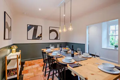 a dining room with a large wooden table and chairs at 5 Bed in Methwold oc-r29770 in Methwold