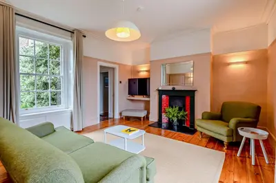 a living room with a couch and a fireplace at 5 Bed in Methwold oc-r29770 in Methwold