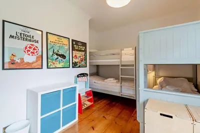 a room with two bunk beds and a blue cabinet at 5 Bed in Methwold oc-r29770 in Methwold