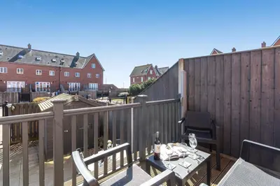 a patio with a table and chairs on a balcony at 3 Bed in Felixstowe oc-p29748 in Felixstowe