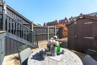 a patio with a table and chairs and a fence at 3 Bed in Felixstowe oc-p29748 in Felixstowe