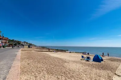 a beach with a blue tent and people on it at 3 Bed in Felixstowe oc-p29748 in Felixstowe