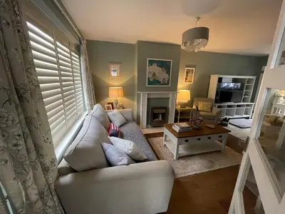 a living room with a couch and a table at Bowershott in Letchworth
