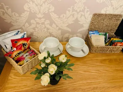 a table with baskets and cups and a vase with flowers at Bowershott in Letchworth