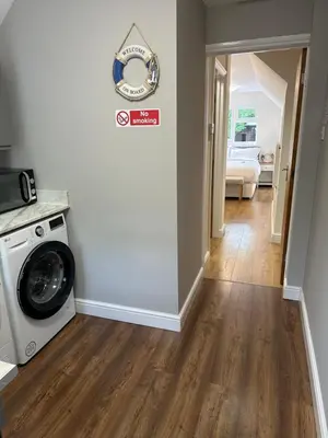 a laundry room with a washer and dryer at The Cosy Place near centre in Ipswich