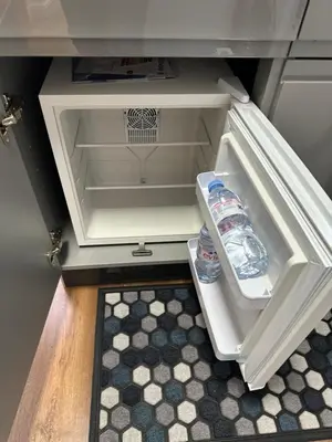 an open refrigerator with two water bottles in it at The Cosy Place near centre in Ipswich