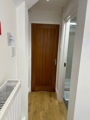 a hallway with a wooden door in a room at The Cosy Place near centre in Ipswich
